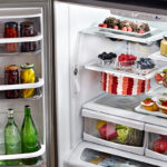 open fridge with drinks and pastries inside